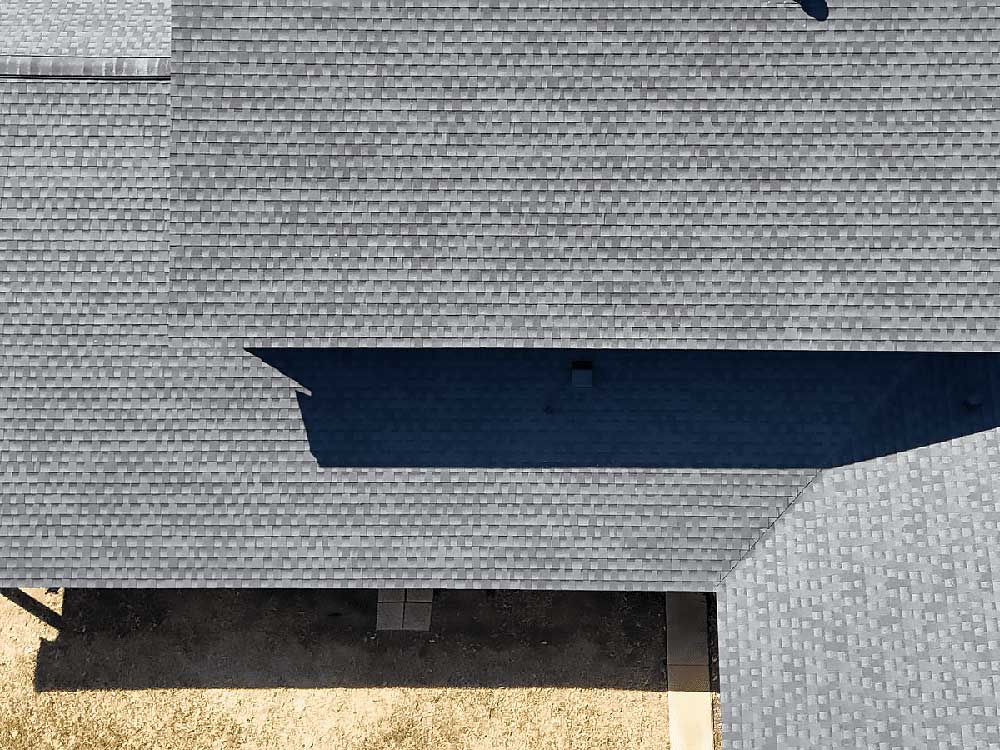 Aerial view of a house with gray shingle roofing, showing clean lines and uniform texture. This image highlights the precision of roof replacement, a service offered by Fort Worth roofing contractors to ensure durability and aesthetic appeal.| Korrect General Contracting Fort Worth TX