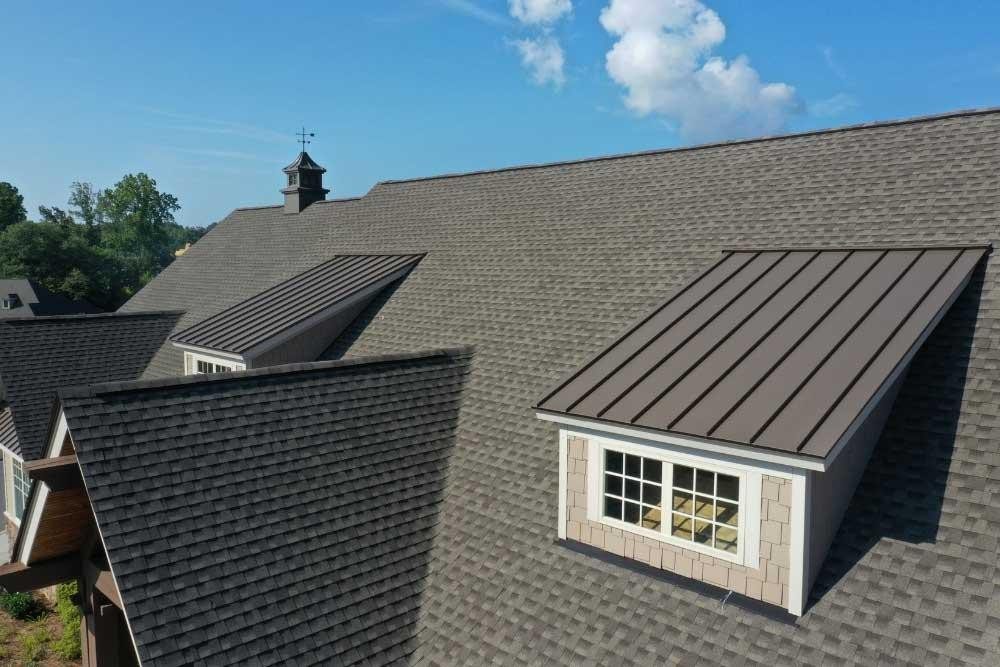 Residential roof with asphalt shingles and dormers, expertly installed by Korrect Roofing.