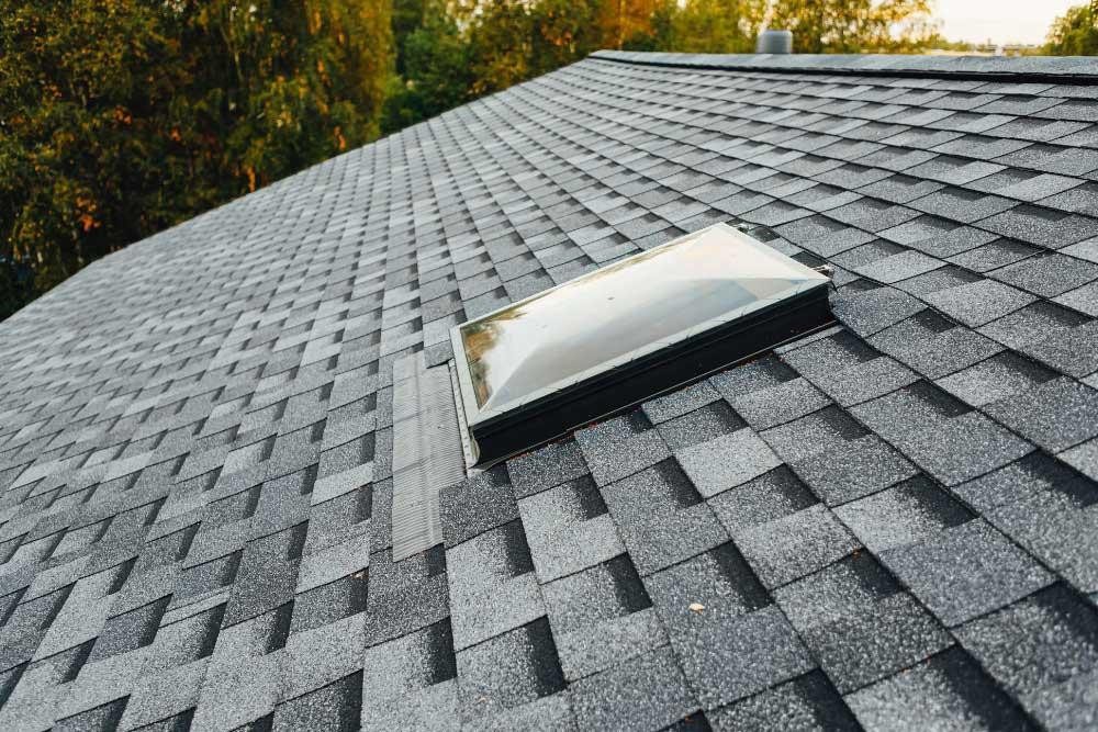 Skylight set into a shingle roof with precise workmanship by Korrect Roofing in Fort Worth.