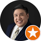 5star-review-image2 A person in a dark suit and striped tie smiles against a black background. The image includes an orange star icon in the corner, suggesting recognition or a rating. This could relate to Fort Worth roofing services or another professional industry.| Korrect General Contracting Fort Worth TX